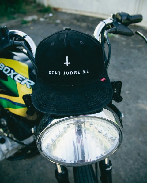 a hat is sitting on the handlebars of a motorcycle