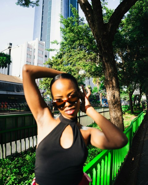 a woman in a black top is posing for a picture