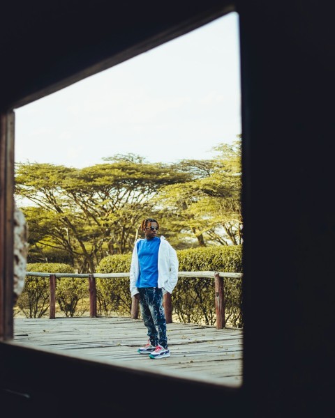 a man standing on top of a wooden deck