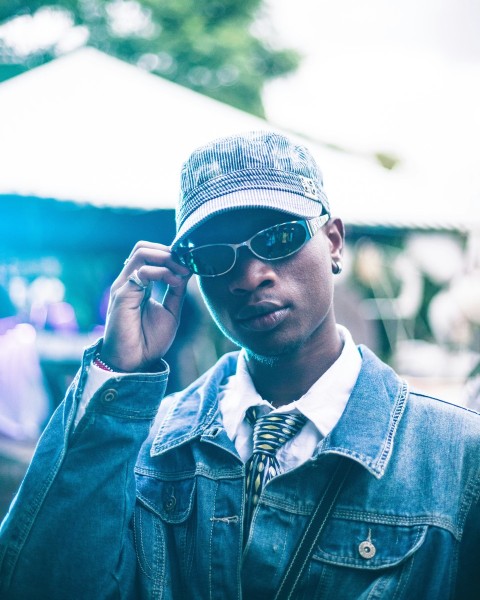 a man wearing sunglasses and a denim jacket