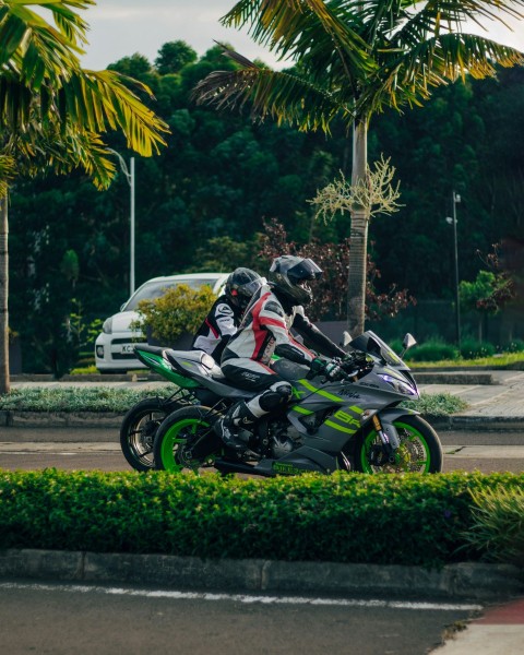 a person riding a motorcycle on a city street WJPh