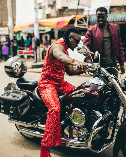 a woman in a red dress sitting on a motorcycle