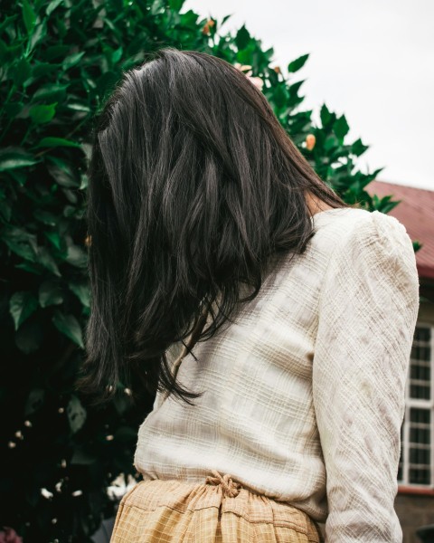 woman in beige long sleeved top