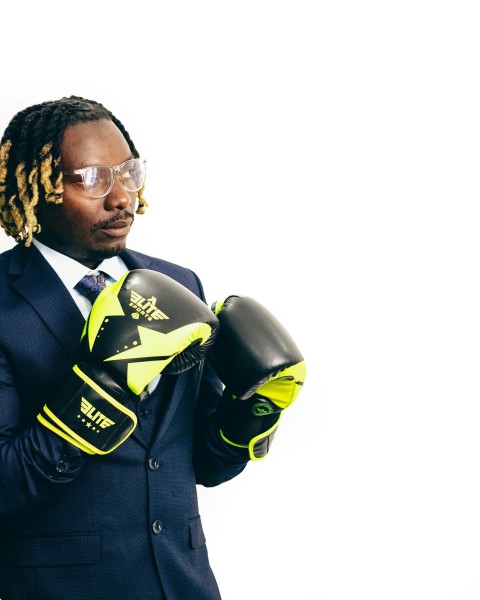 a man wearing a suit and boxing gloves