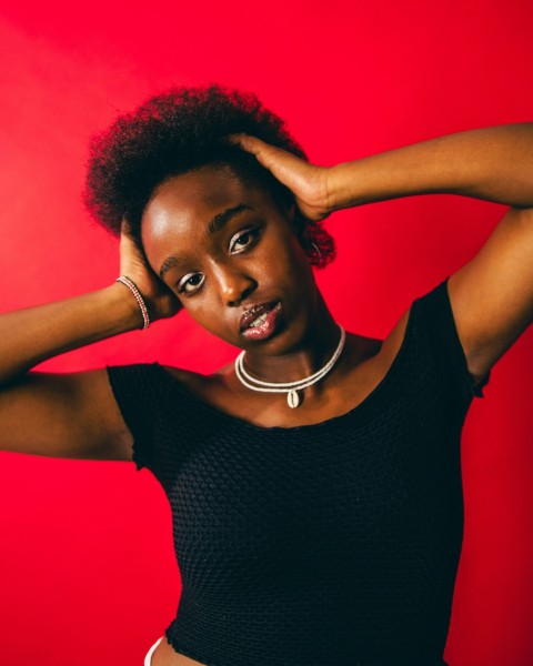 a woman in a black top is posing for a picture