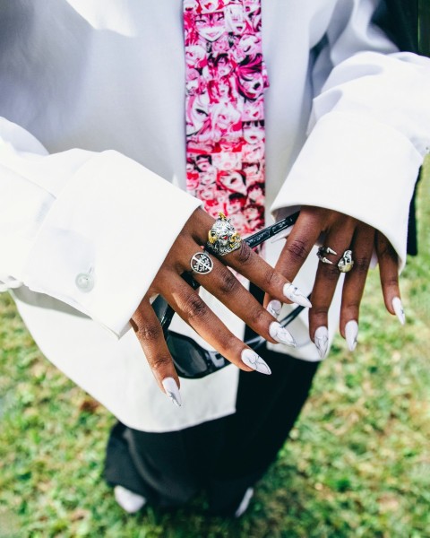 a person in a suit and tie holding a cell phone