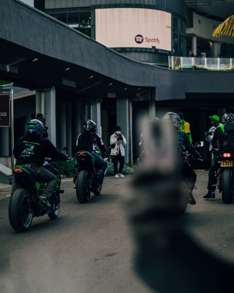 a group of people riding motorcycles down a street