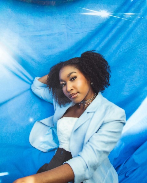 a woman laying down on a blue sheet