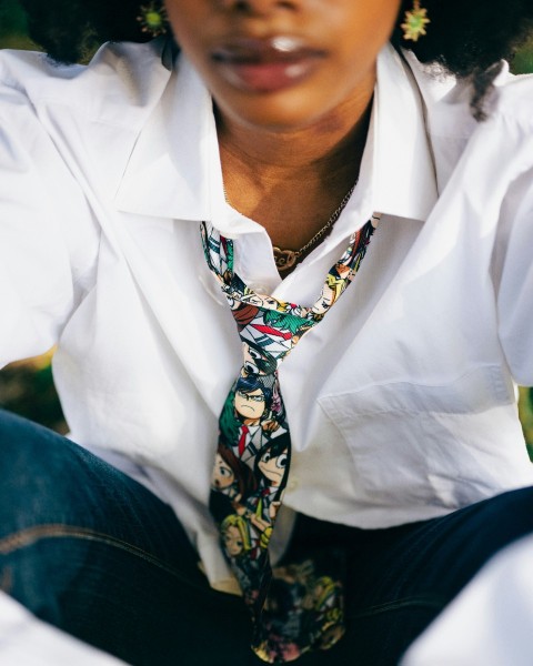 a woman wearing a white shirt and a tie