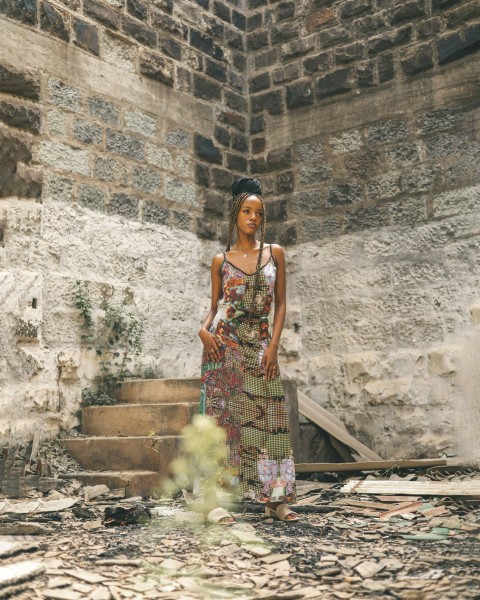 a woman standing in front of a brick wall SPO