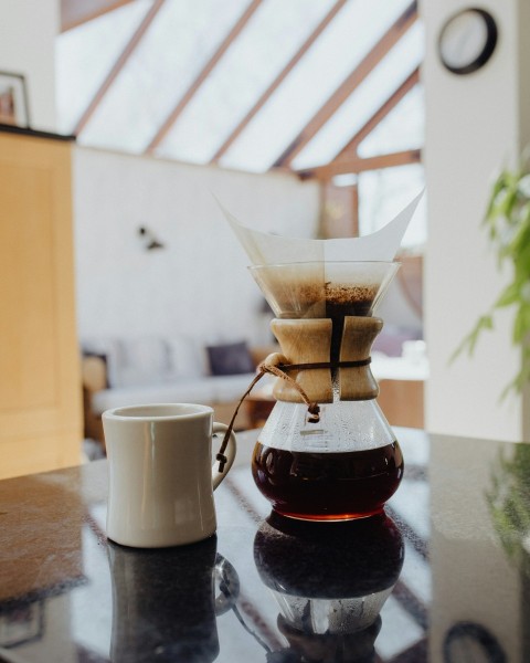 white ceramic mug on brown wooden table emHyJ