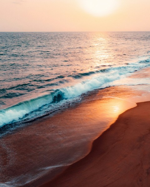 ocean waves crashing on shore during daytime