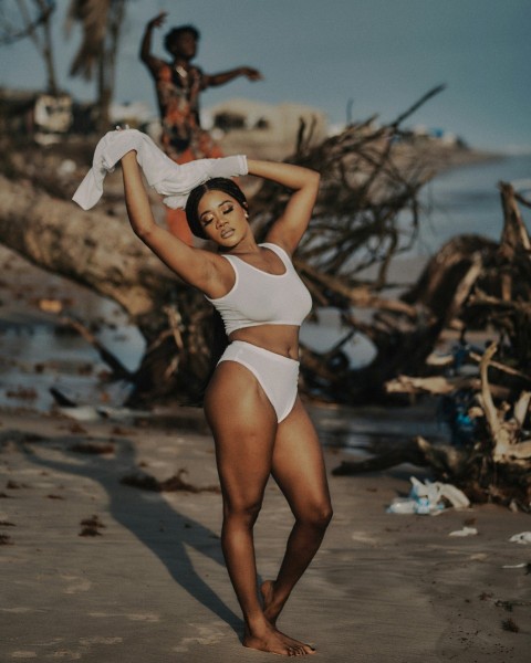 a woman in a white bikini standing on a beach