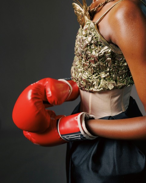 a woman in a dress and red boxing gloves _F88vCMl