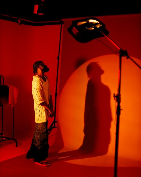 a man standing in front of a red light