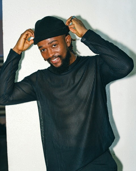 a man with a black hat and a black shirt