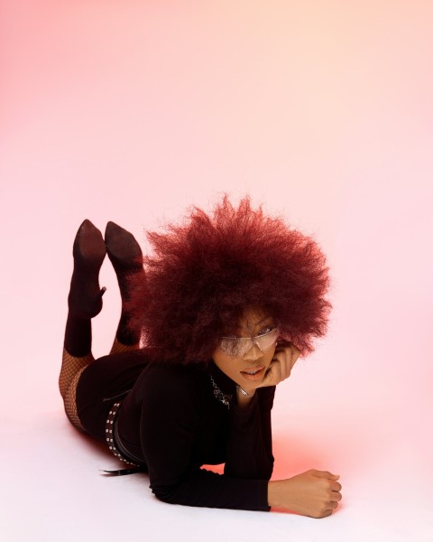 a woman with red hair laying on the ground