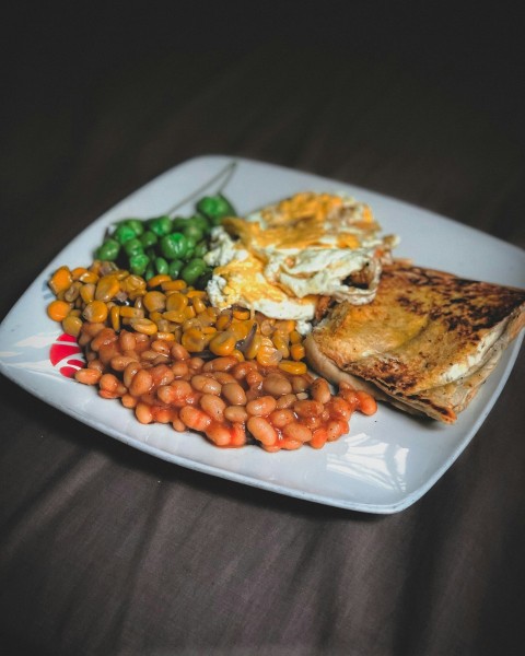 fried meat with green beans on white ceramic plate