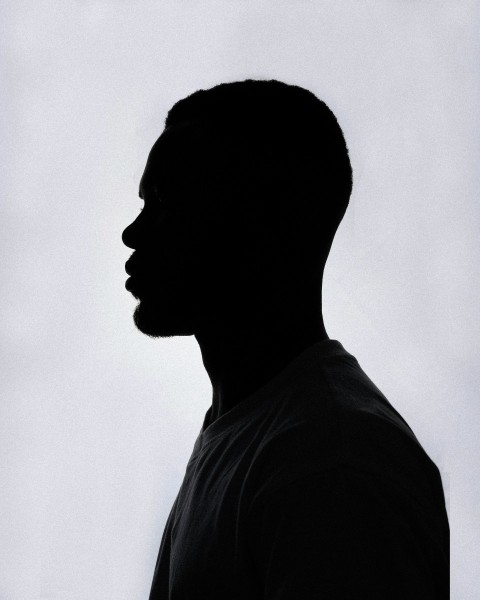 a silhouette of a man in a black shirt