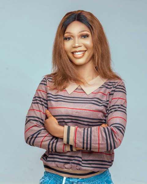 woman in gray red and white striped long sleeve shirt smiling