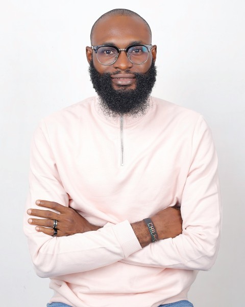 a man with a beard and glasses posing for a picture