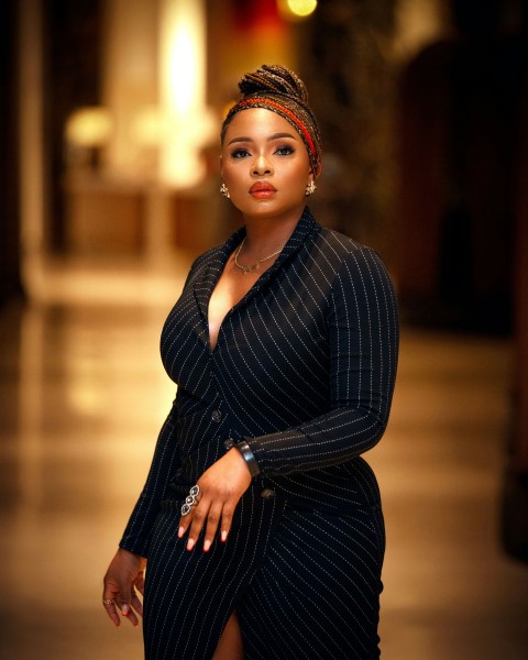 a woman in a black and white dress posing for a picture