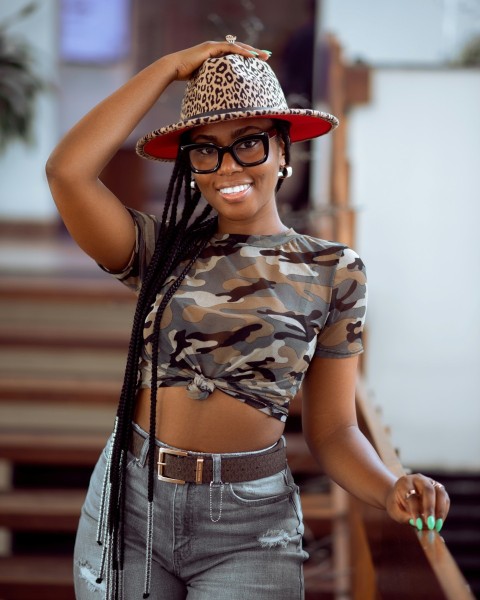 a woman wearing a leopard print hat and glasses WHtN