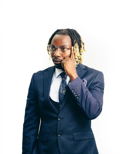 a man in a suit and tie holding a cell phone to his ear