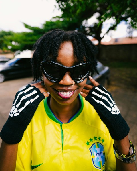 a woman wearing a yellow shirt and black sunglasses