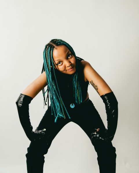 a woman with green dreadlocks posing for a picture X9L