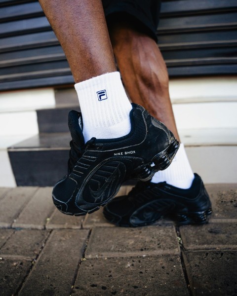 a close up of a persons feet wearing black and white socks