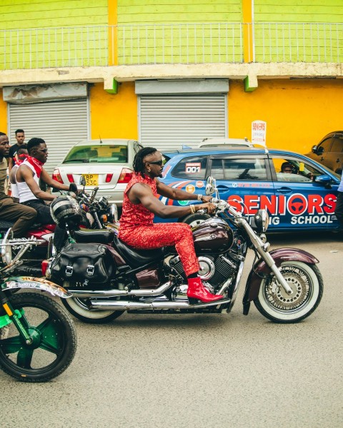 a man riding a motorcycle with a woman on the back of it 2N_