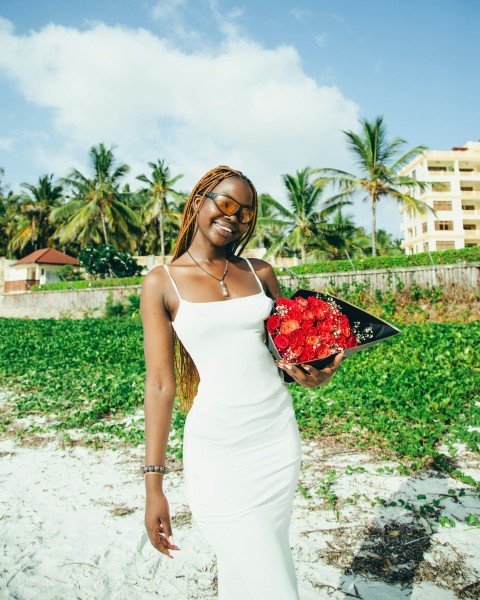 a woman in a white dress holding a bouquet of flowers