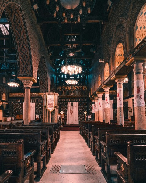 the interior of a church with pews and stained glass windows