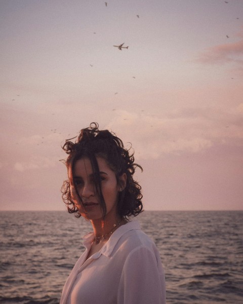 woman in white shirt standing near body of water during daytime UX