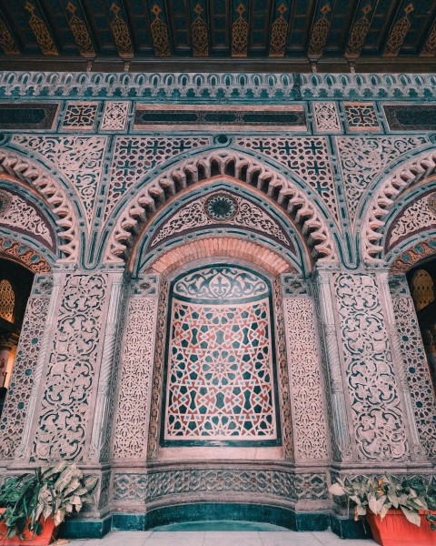 a building with a large window and a planter in front of it 1b5nDtKL