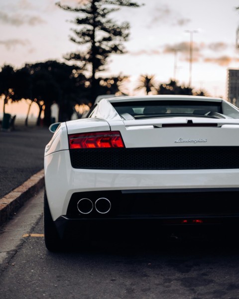 a white sports car parked in a parking lot