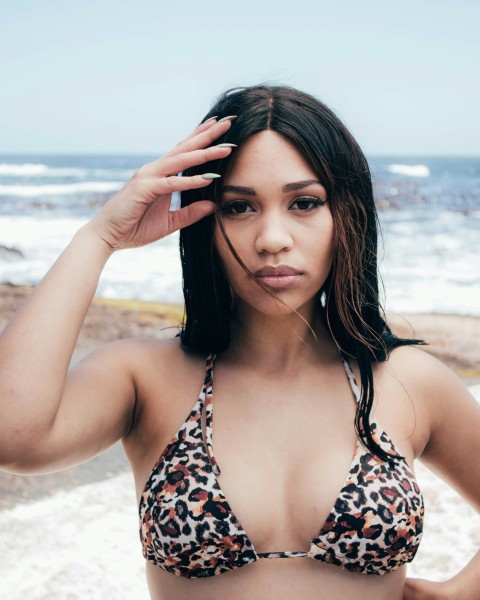 woman in black and white floral bikini top standing on beach during daytime