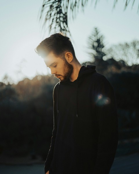 man in black hoodie standing during daytime