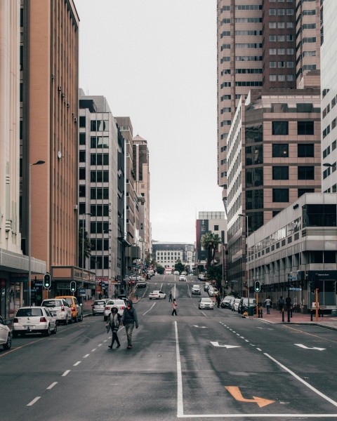 cars on road near high rise buildings during daytime