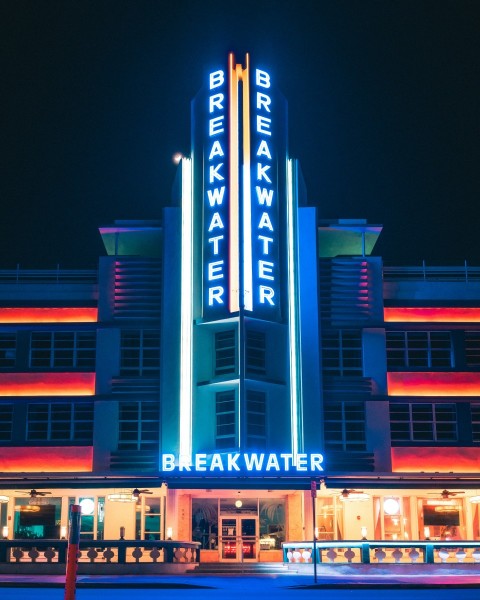 a large building with a neon sign on its side