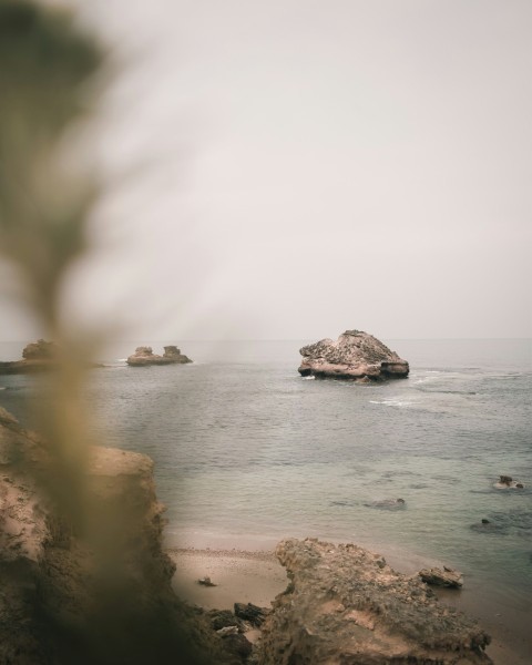 a rock outcropping in the middle of a body of water