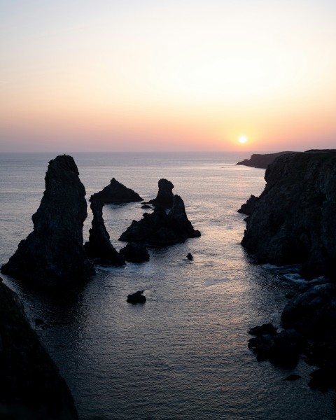 a body of water with rocks in the middle of it