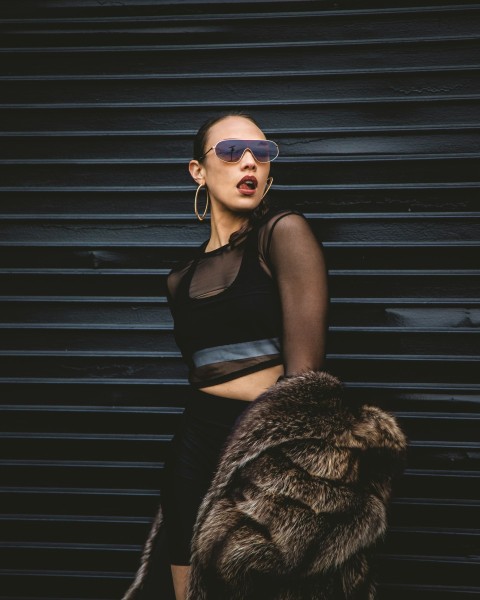 woman standing and leaning on wall