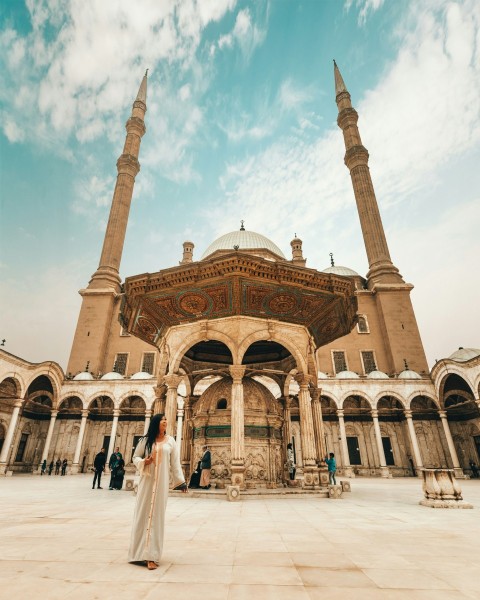 woman standing near mosque during daytime