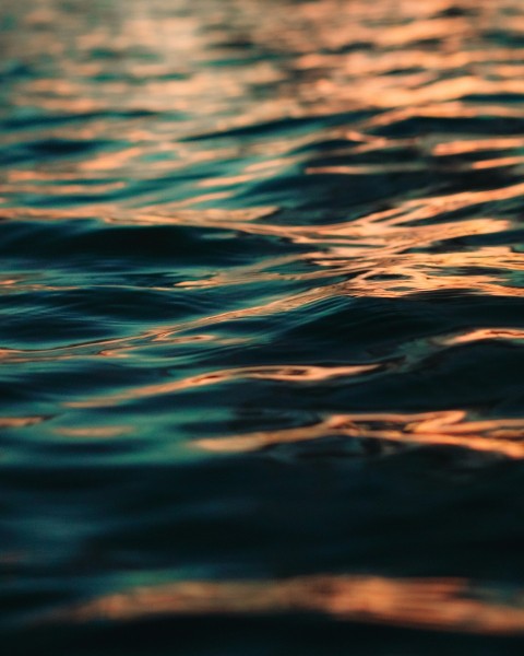 a body of water with clouds above it