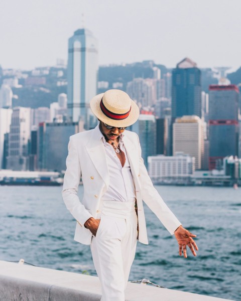 woman in white coat and white hat standing on dock during daytime mwJ 503_