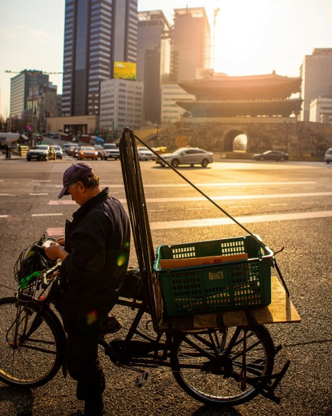 man standing beside the bicycle