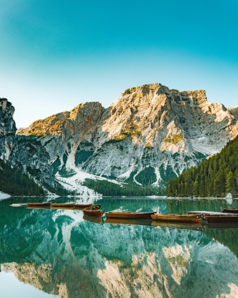 brown wooden dock on lake near mountain range BX