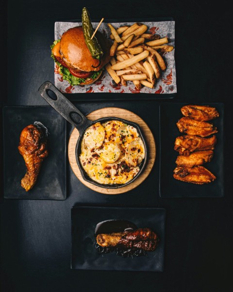 a table topped with plates of food and a burger H8pi3